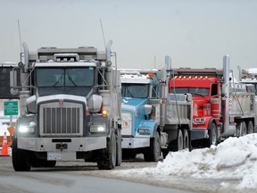 Trucks line up to dump snow cleared from the runways at Vancouver International Airport (YVR) as Environment Canada has issued a weather alert warning of heavy snow followed by freezing rain on Friday.
