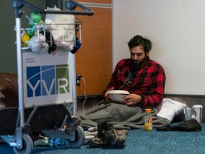 Paul-Hugo Mena-Ouimet set up camp in a corner of Vancouver International Airport on Dec. 23, 2022, waiting for his flight to Montreal.