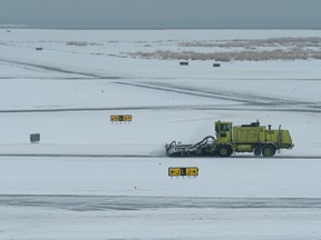 Snow clearing machines work at Vancouver International Airport in Richmond, BC, December, 23, 2022.