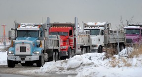 Trucks line up to dump snow cleared from the runways at Vancouver International Airport (YVR) on Dec. 22, 2022.