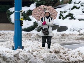 Pedestrians navigate slushy streets after a week of snow and sleet before it turned to rain on Dec. 24, 2022.