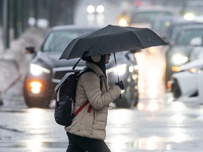 Pedestrians navigate Metro Vancouver streets during a heavy rainfall warning on Dec. 24, 2022. Richard Lam photo/PNG
