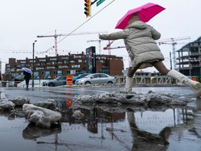Pedestrians navigate slushy streets in Metro Vancouver after a week of snow and sleet before it turned to rain on Dec. 24, 2022. Richard Lam photo/PNG