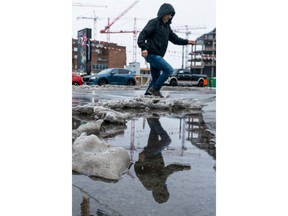 Pedestrians navigate slushy streets after a week of snow and sleet before it turned to rain on Dec. 24, 2022. Richard Lam photo/PNG