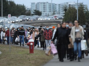 Boxing Day shoppers leave on foot and by car at the McArthurGlen Designer Outlet in Richmond, BC., on December 26, 2022.