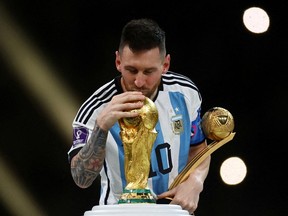 Argentina captain Lionel Messi kisses the World Cup trophy after receiving the Golden Ball award for top tournament player as he celebrates his country's FIFA World Cup final win over France on penalties in Lusail, Qatar, last Sunday.