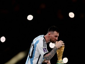 Argentina's Lionel Messi celebrates with the trophy after winning the FIFA World Cup in Lusail, Qatar, on Dec. 18, 2022.