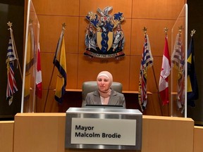 “I think Richmond is really open to everyone,” says Sara Kanafani, a Grade 11 student who is learning about the workings of city hall and volunteering to talk to seniors about their lives. Here Kanafani tries out Richmond mayor’s chair at city hall.