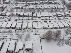 An aerial view of snow-covered houses in Vancouver, Sunday, Dec. 18, 2022.