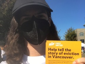 Dr. Sarah Marsden, holding a flyer for the eviction mapping project that she is running.