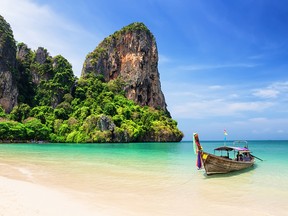 A traditional wooden longtail boat at Railay Beach in Thailand.