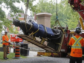 A statue of Canada’s founding prime minister — and architect of the since-reviled Indian Residential Schools — John A. Macdonald gets dismantled and taken away in his hometown of Kingston, Ont., in the summer of 2021.