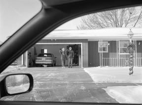 Deanna Dyckman's 1998 photo of a mother and father waving goodbye at their home in Sioux City, Iowa.