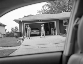Deanna Dyckman's 2005 photo of a mother and father waving goodbye at their home in Sioux City, Iowa.