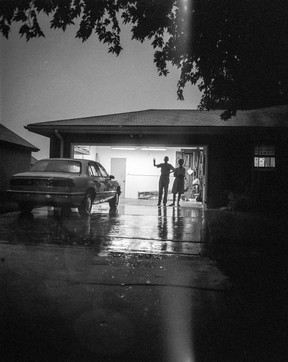 Deanna Dyckman's 1996 photo of a mother and father waving goodbye at their home in Sioux City, Iowa.