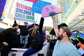 Protesters sit in the back of a pickup truck outside of the Coquitlam City Centre library where a Drag Queen Story Time took place on Jan. 14, 2023.