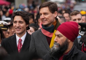 From left, Prime Minister Justin Trudeau, B.C. Premier David Eby and federal NDP Leader Jagmeet Singh prepare to march in the Lunar New Year parade in Vancouver on Sunday.