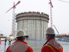 FortisBC Holdings Inc. says it has signed a deal with a B.C. First Nation over the Tilbury liquefied natural gas expansion projects. Construction workers look on at the FortisBC Tilbury LNG expansion project in Delta, B.C., Monday, Nov. 16, 2015.