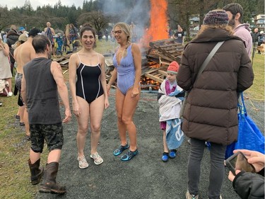 Shellie Kamari (left) and Szilvi Pal (striped suit) at the 2023 Penguin Plunge in Deep Cove on January 1, 2023.