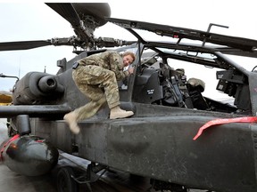 In this image released on January 21, 2013, Prince Harry makes early morning checks as he sits on an Apache helicopter at the British controlled flight-line at Camp Bastion on Dec. 12, 2012 in Afghanistan.