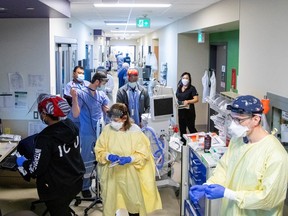 Nurses, doctors, and respiratory therapists prepare to intubate a COVID patient as Omicron puts pressure on Humber River Hospital in Toronto in January 2022.