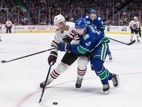 Jonathan Toews (left, battling with Canucks defenceman Quinn Hughes) could be making his last Rogers Arena appearance in Blackhawks colours on Tuesday.