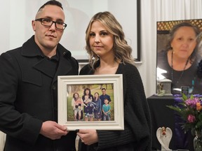 Jason Keller and Santaya Garnot with family photos at the memorial on Jan. 28 for their mother, Kelly Ashton, who lived in Prince George's Simon Fraser Lodge before falling twice and later dying.