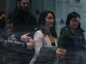 Jennifer Chan, front centre, the sister of late Vancouver Police Const. Nicole Chan, who died by suicide in 2019, returns to a coroner's inquest, in Burnaby, B.C., on Monday, Jan. 23, 2023. A Vancouver Police sergeant who says he was Nicole Chan's friend and mentor has told a coroner's inquest that Chan believed she would never return to work because human resource officers went to the hospital when she was apprehended under the Mental Health Act.