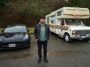 Lucas Philips is pictured outside his camper and next to his Tesla in a parking lot where he has been living at Spanish Banks, in Vancouver, B.C., Thursday, Dec. 8, 2022. Philips is part of Metro Vancouver's camper community, some living on wheels as an economic strategy, some as a lifestyle choice and others as a last resort.