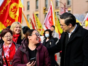 Federal Conservative Party leader Pierre Poilievre greets parade watchers during the Chinatown Spring Festival Parade, part of Lunar New Year celebrations in Vancouver on Sunday.