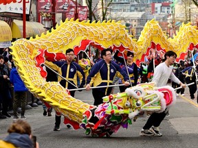 People attend the annual Chinatown Spring Festival Parade, part of Lunar New Year celebrations in Vancouver on Sunday.