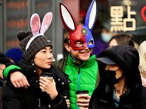 A couple watches the Chinatown Spring Festival Parade, part of the Lunar New Year celebrations in Vancouver's Chinatown on Sunday.