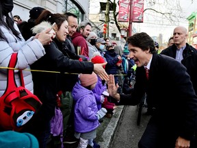 Prime Minister Justin Trudeau waves to people at the Chinatown Spring Festival Parade, amid Lunar New Year celebrations, in Vancouver on Sunday.