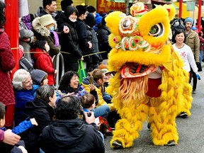 People attend the annual Chinatown Spring Festival Parade, part of Lunar New Year celebrations in Vancouver on Sunday.