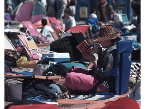 1995:  Pat Savola reads a book as she waits in front of the Main stage at the Folk Festival. She has been coming to the festival since 1981.