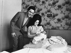 FILE - Lisa Marie Presley poses for her first picture, in the lap of her mother, Priscilla, on Feb. 5, 1968, with her father, Elvis Presley. Lisa Marie Presley -- the only child of Elvis Presley and a singer herself -- was hospitalized Thursday, Jan. 12, 2023, her mother said in a statement.