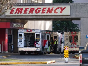A paramedic is seen outside ambulances parked at the entrance to the emergency department at Richmond General Hospital on Nov. 27, 2022.