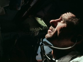 Astronaut Walter Cunningham, pictured looking out the capsule window during his lone space mission aboard Apollo 7 in October 1968.