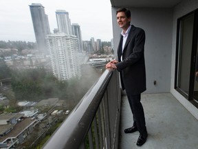 Premier David Eby on the balcony of a suite at the 115 Place Housing Co-operative in Burnaby, following the announcement of rental housing protections, on Thursday, January 12, 2023.
