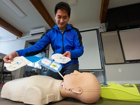 Bryan Wong of Pacific First Aid demonstrates applying an AED, or automatic external defibrillator.