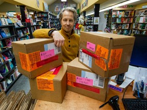 Book Warehouse's David Anderson with unopened boxes of Prince Harry's memoir, Spare, in Vancouver on Jan. 8, 2023. Book Warehouse has four boxes of the books in store and they cannot be opened until its release on Tuesday.