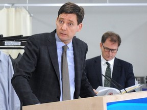 Premier David Eby, with Health Minister Adrian Dix in the background, during an announcement Monday on new supports for internationally educated nurses.