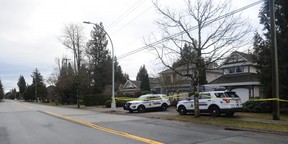 The Integrated Homicide Investigation Team (IHIT) have a Surrey home behind police tape on January 10, 2023, after three bodies were discovered inside.