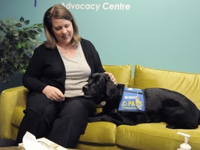 Leah Zille, Executive Director of The Treehouse Vancouver Child and Youth Advocacy Centre, with Nessa the support dog.