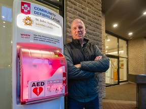 Patrick Stafford-Smith standing with an outdoor automated external defibrillator outside 124 West 1st St. in North Vancouver.