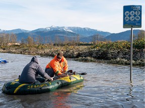 Two men explore Delair Park in their inflatable boat in Abbotsford after severe flooding in 2021.
