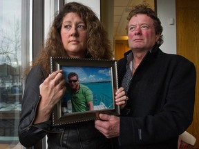 Margie and Mark Gray hold a picture in 2016 of their son Myles Gray. Four of the Vancouver police officers involved in his 2015 death were already under investigation because of an incident that left a man with a broken jaw just six weeks earlier.