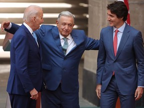 U.S. President Joe Biden, President of Mexico Andres Manuel Lopez Obrador and Prime Minister of Canada Justin Trudeau hug each other during a message for the media as part of the 2023 North American Leaders Summit at Palacio Nacional on Jan. 10, in Mexico City.