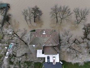 Water from the rainstorm-swollen Sacramento River surrounds a home in West Sacramento, California, U.S. January 11, 2023.  REUTERS/Fred Greaves