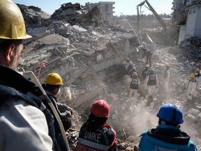 Coal miners work on a collapsed building to find a earthquake victim in Islahiye, Turkey. on Feb. 13, 2023.